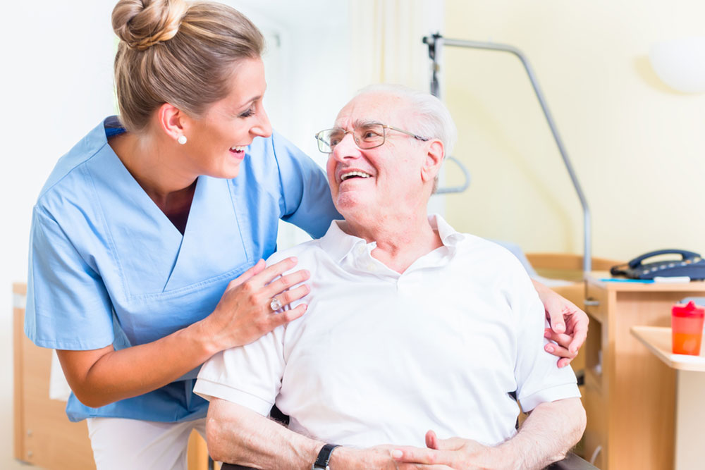 Senior man and old age nurse in nursing home